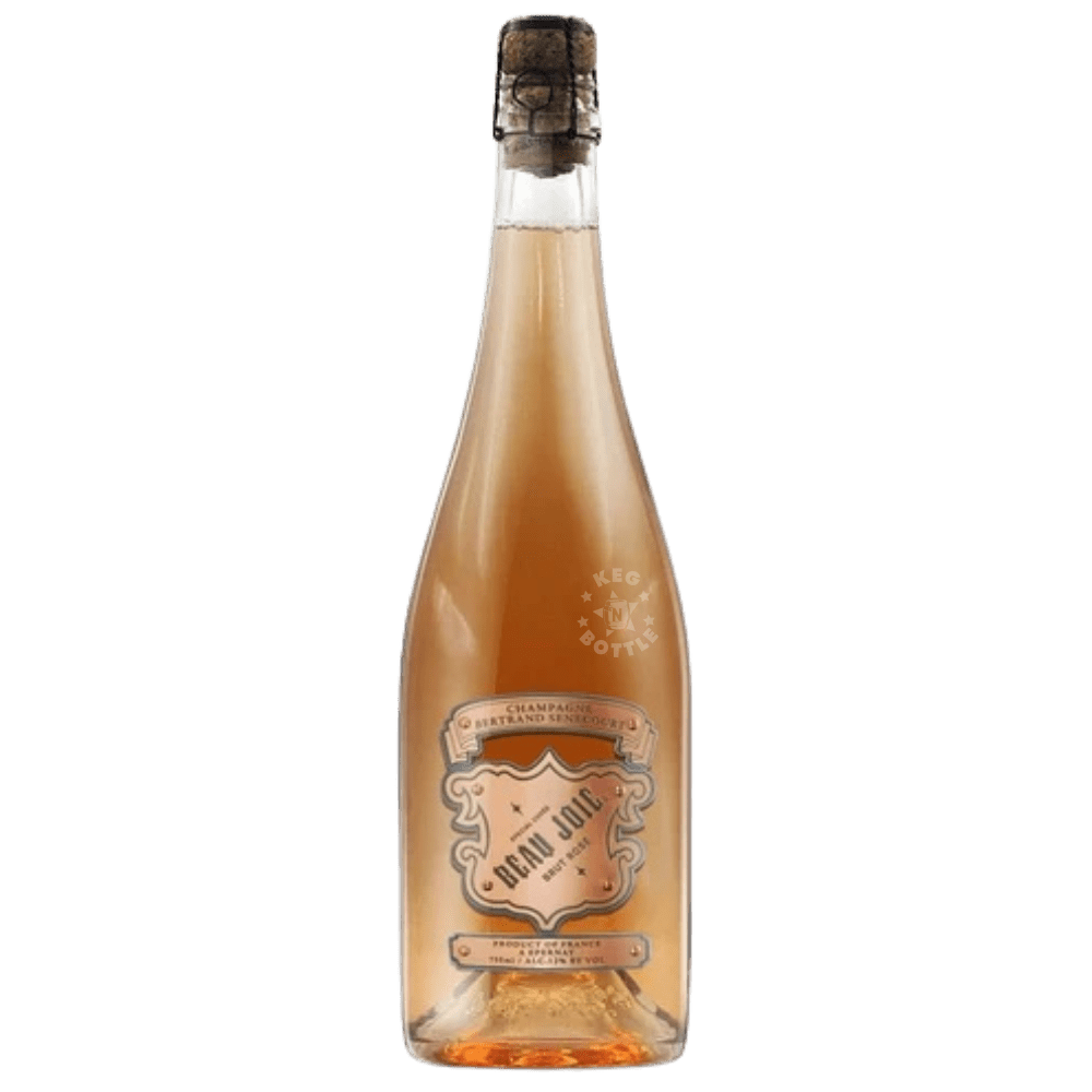 Beau Joie Rosé Champagne Uncaged 750mL bottle featuring pale salmon-pink Champagne, an elegant decorative label, and dark foil-covered cork.