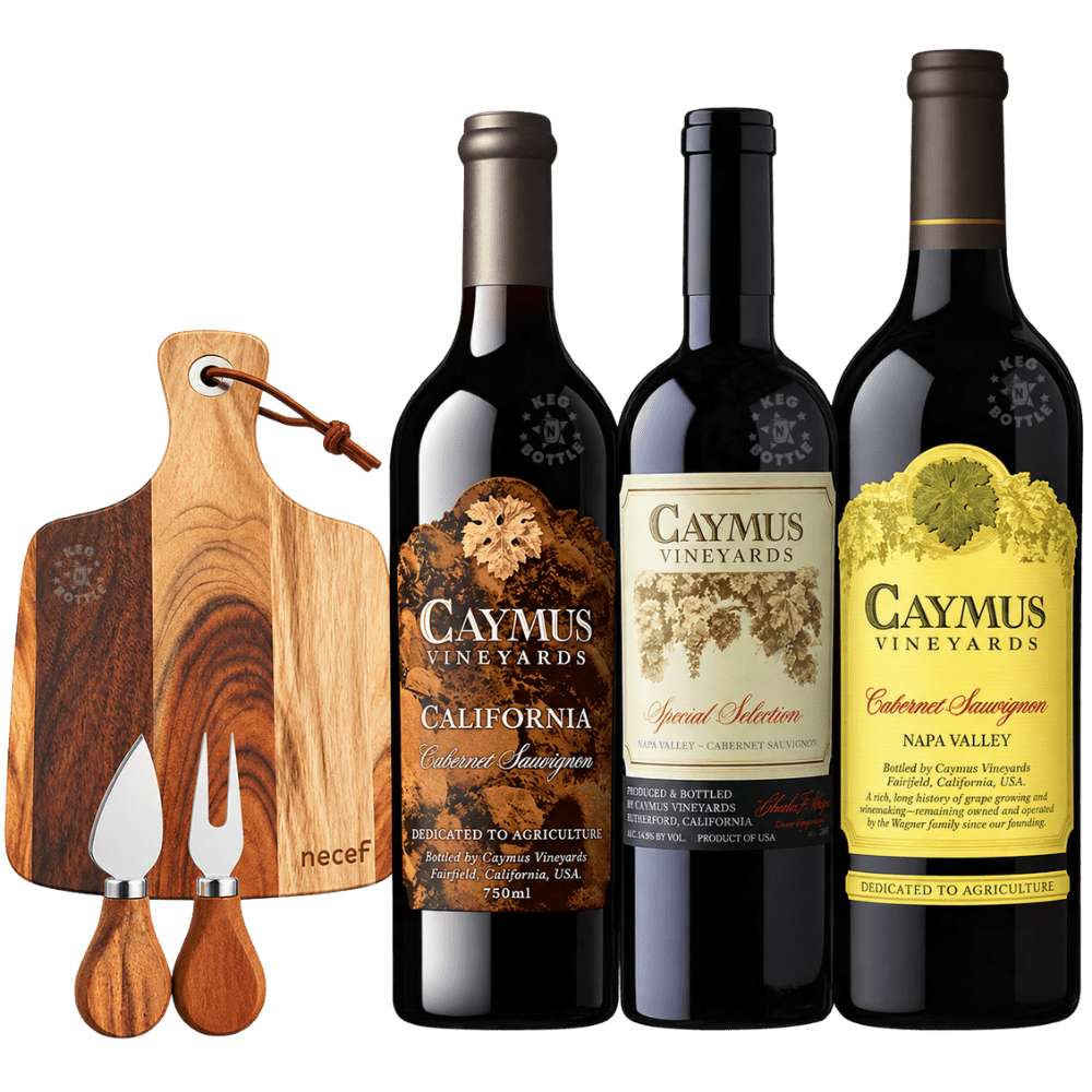 Caymus Cabernet Sauvignon wine and charcuterie gift set featuring three bottles of Caymus Vineyards Cabernet Sauvignon, including Napa Valley 1L, California 750mL, and Special Selection 750mL, alongside an acacia wood cheese board with matching knife and fork.