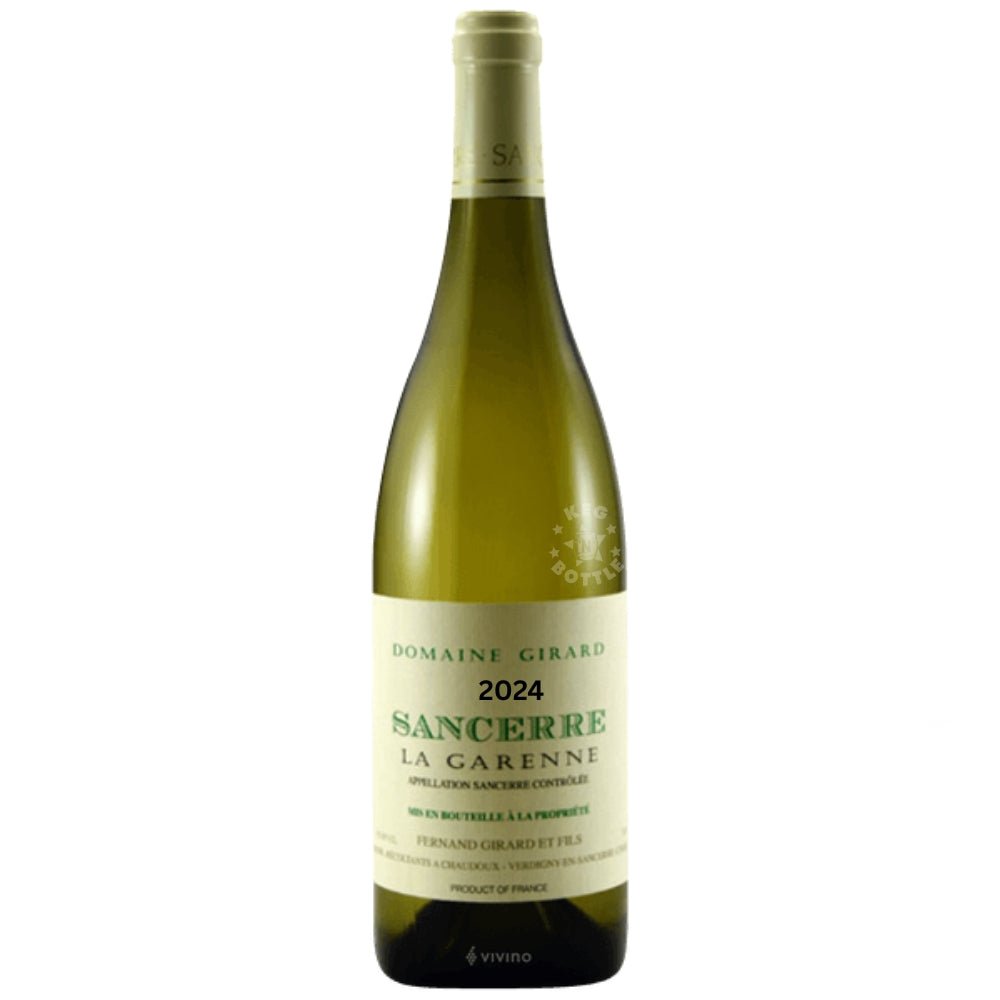 Bottle of Domaine Fernand Girard Sancerre “La Garenne” 2024 white wine held in hand in a wine shop, showing cream label with green text.