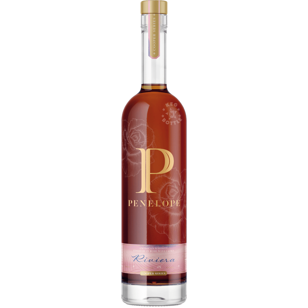 Bottle of Penelope Riviera Toasted Coconut Finished Whiskey with floral pink label and amber whiskey inside clear glass bottle