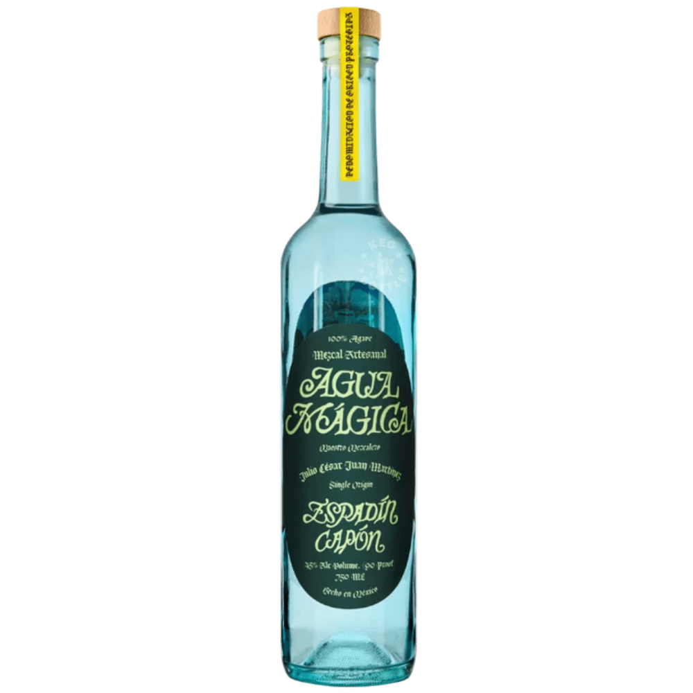 Agua Mágica Mezcal Espadín Capón 750mL turquoise glass bottle featuring a dark green decorative label, gold lettering, and natural cork stopper.